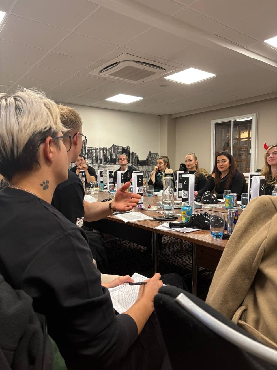Colleagues laughing and deducing during a Mafia Kilty corporate game